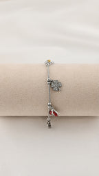 Bracciale con charms margherita coccinella e quadrifoglio