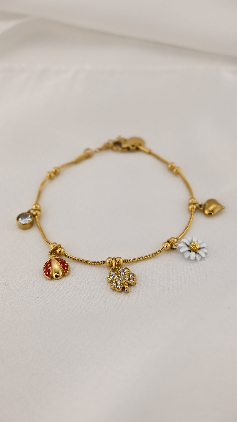 Bracciale con charms margherita coccinella e quadrifoglio