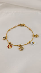 Bracciale con charms margherita coccinella e quadrifoglio
