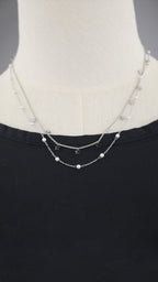 Collana doppia catena con simboli e perle