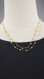 Collana doppia catena con simboli e perle